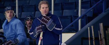 Movie still from “Miracle” (2004), directed by Gavin O'Connor – A man holding a hockey stick while standing on a hockey rink; Medium shot, High angle