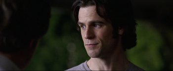 Movie still from “Miracle” (2004), directed by Gavin O'Connor – A man with long dark hair and blue eyes; Close Up shot, Over the shoulder angle