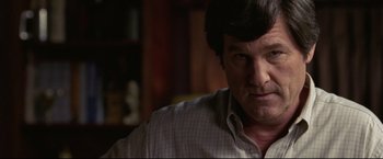 Movie still from “Miracle” (2004), directed by Gavin O'Connor – A person wearing a dress shirt; Close Up shot, Over the shoulder angle