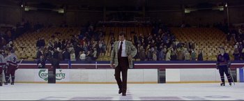 Movie still from “Miracle” (2004), directed by Gavin O'Connor – A man in a suit and tie walking across a ice rink; Wide shot, Low angle