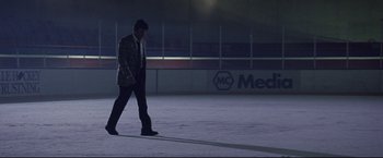 Movie still from “Miracle” (2004), directed by Gavin O'Connor – A man walking across a ice rink at night; Wide shot, Low angle