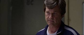 Movie still from “Miracle” (2004), directed by Gavin O'Connor – An older man is looking at the camera; Close Up shot, Over the shoulder angle