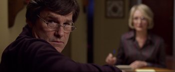 Movie still from “Miracle” (2004), directed by Gavin O'Connor – A person wearing glasses; Close Up shot, Over the shoulder angle