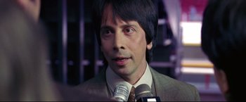 Movie still from “Miracle” (2004), directed by Gavin O'Connor – A person talking on a microphone; Close Up shot, Over the shoulder angle