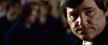 Movie still from “Miracle” (2004), directed by Gavin O'Connor – A man's face in a crowd of onlookers; Close Up shot, Low angle
