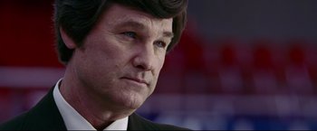 Movie still from “Miracle” (2004), directed by Gavin O'Connor – A person wearing a suit and tie; Close Up shot, Over the shoulder angle