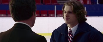 Movie still from “Miracle” (2004), directed by Gavin O'Connor – A man wearing a suit and tie talking to another man in a suit; Close Up shot, Over the shoulder angle