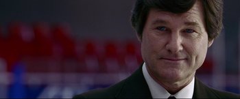 Movie still from “Miracle” (2004), directed by Gavin O'Connor – A person wearing a suit and tie; Close Up shot, Low angle