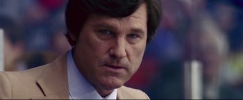 Movie still from “Miracle” (2004), directed by Gavin O'Connor – A person wearing a suit and tie; Close Up shot, Low angle