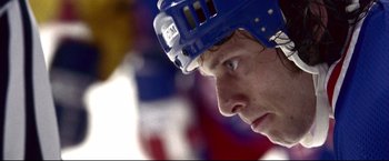 Movie still from “Miracle” (2004), directed by Gavin O'Connor – A hockey player's face with a helmet on; Extreme Close Up shot, Low angle