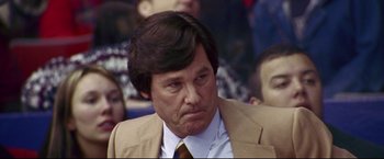 Movie still from “Miracle” (2004), directed by Gavin O'Connor – A person wearing a suit and tie; Close Up shot, Low angle