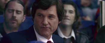 Movie still from “Miracle” (2004), directed by Gavin O'Connor – A person wearing a suit and tie; Close Up shot, Low angle