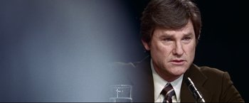 Movie still from “Miracle” (2004), directed by Gavin O'Connor – A person wearing a suit and tie; Close Up shot, Over the shoulder angle