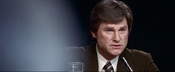 Movie still from “Miracle” (2004), directed by Gavin O'Connor – A person wearing a suit and tie; Close Up shot, Over the shoulder angle