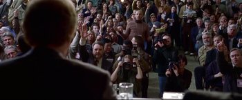 Movie still from “Miracle” (2004), directed by Gavin O'Connor – A group of people standing in front of a crowd of onlookers; Medium shot, High angle