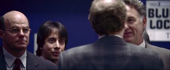 Movie still from “Miracle” (2004), directed by Gavin O'Connor – A man in a business suit talking to another man in a business suit; Close Up shot, Over the shoulder angle