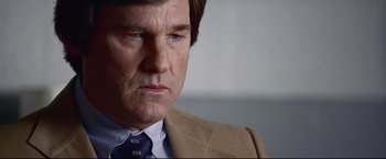 Movie still from “Miracle” (2004), directed by Gavin O'Connor – A person wearing a suit and tie; Close Up shot, Low angle