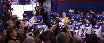 Movie still from “Miracle” (2004), directed by Gavin O'Connor – A group of men in blue and white hockey uniforms; Medium shot, Over the shoulder angle