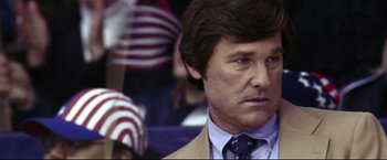 Movie still from “Miracle” (2004), directed by Gavin O'Connor – A person wearing a suit and tie; Close Up shot, Low angle