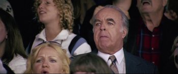 Movie still from “Miracle” (2004), directed by Gavin O'Connor – An older man in a suit and tie looking at something; Close Up shot, Low angle
