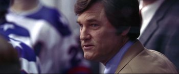 Movie still from “Miracle” (2004), directed by Gavin O'Connor – A person wearing a suit and tie; Close Up shot, Low angle