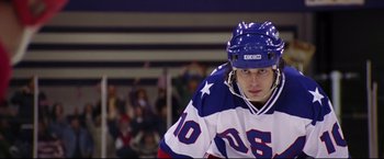 Movie still from “Miracle” (2004), directed by Gavin O'Connor – A hockey player wearing a blue and white uniform; Medium shot, Low angle