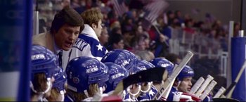 Movie still from “Miracle” (2004), directed by Gavin O'Connor – A group of people wearing blue and white hockey helmets; Medium shot, Over the shoulder angle