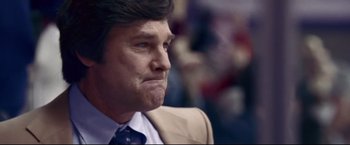 Movie still from “Miracle” (2004), directed by Gavin O'Connor – A person wearing a suit and tie; Close Up shot, Low angle