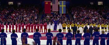 Movie still from “Miracle” (2004), directed by Gavin O'Connor – A group of men standing on top of an ice rink; Wide shot, High angle