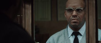 Movie still from “Miracle at St. Anna” (2008), directed by Spike Lee – A man with glasses is looking at the camera; Close Up shot, Over the shoulder angle