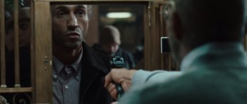 Movie still from “Miracle at St. Anna” (2008), directed by Spike Lee – A man is looking in the mirror while another man is holding a camera; Close Up shot, Over the shoulder angle