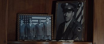 Movie still from “Miracle at St. Anna” (2008), directed by Spike Lee – A picture of a man in a military uniform and another picture of a man in a military uniform; Extreme Close Up shot, Low angle
