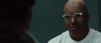 Movie still from “Miracle at St. Anna” (2008), directed by Spike Lee – An older man wearing glasses and a white shirt; Close Up shot, Over the shoulder angle