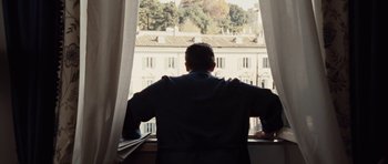 Movie still from “Miracle at St. Anna” (2008), directed by Spike Lee – A man looking out of a window at a building; Medium shot, Low angle