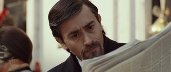 Movie still from “Miracle at St. Anna” (2008), directed by Spike Lee – A person reading a newspaper; Close Up shot, High angle