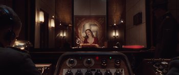 Movie still from “Miracle at St. Anna” (2008), directed by Spike Lee – A woman in a red dress sitting in front of a mirror; Medium shot, Overhead angle