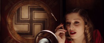 Movie still from “Miracle at St. Anna” (2008), directed by Spike Lee – A woman is talking on a cell phone in front of a mirror; Close Up shot, High angle