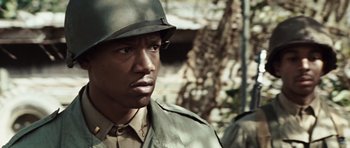 Movie still from “Miracle at St. Anna” (2008), directed by Spike Lee – A man in a military uniform wearing a helmet; Close Up shot, Over the shoulder angle