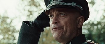 Movie still from “Miracle at St. Anna” (2008), directed by Spike Lee – A man in a uniform saluting with his hand on his head; Close Up shot, Low angle