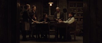 Movie still from “Miracle at St. Anna” (2008), directed by Spike Lee – A group of people sitting around a table; Wide shot, High angle