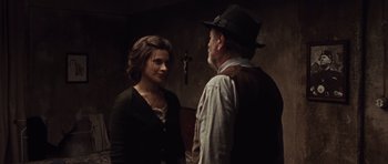 Movie still from “Miracle at St. Anna” (2008), directed by Spike Lee – A man and a woman standing next to each other in a room; Medium shot, Over the shoulder angle