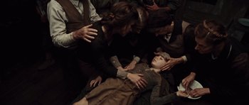 Movie still from “Miracle at St. Anna” (2008), directed by Spike Lee – A group of people surrounding a young girl; Medium shot, High angle