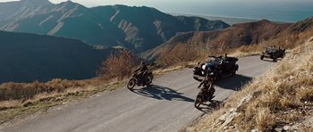Movie still from “Miracle at St. Anna” (2008), directed by Spike Lee – A group of people riding motorcycles on a mountain road; Extreme Wide shot, High angle
