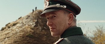 Movie still from “Miracle at St. Anna” (2008), directed by Spike Lee – A man in a military uniform is looking at the camera; Close Up shot, Low angle