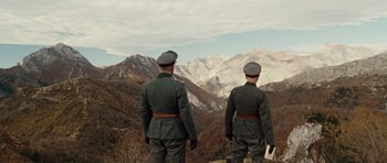 Movie still from “Miracle at St. Anna” (2008), directed by Spike Lee – A couple of men standing on top of a hill; Wide shot, Low angle