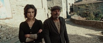 Movie still from “Miracle at St. Anna” (2008), directed by Spike Lee – A man and a woman standing next to each other on a street; Medium shot, Low angle