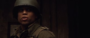 Movie still from “Miracle at St. Anna” (2008), directed by Spike Lee – A man in a military uniform is looking at the camera; Close Up shot, Low angle