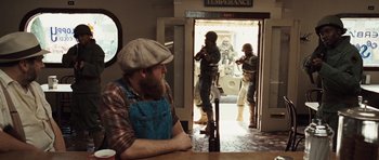 Movie still from “Miracle at St. Anna” (2008), directed by Spike Lee – A group of men standing in a room; Medium shot, Over the shoulder angle