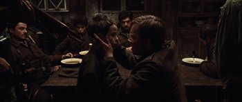 Movie still from “Miracle at St. Anna” (2008), directed by Spike Lee – A group of people sitting around a table; Medium shot, Over the shoulder angle