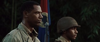 Movie still from “Miracle at St. Anna” (2008), directed by Spike Lee – A man in a military uniform standing next to another man in an army uniform; Close Up shot, Over the shoulder angle